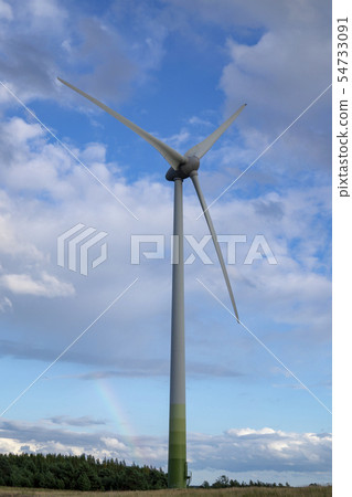 wind power turbine against cloudy blue sky 54733091