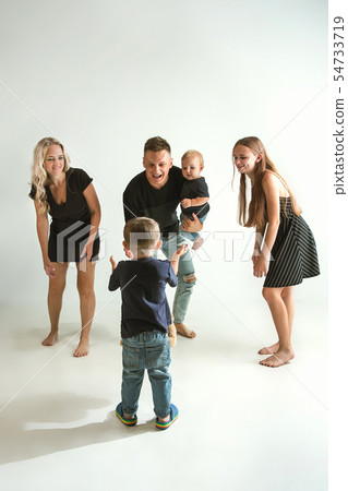 Young family spending time together and smiling Young family spending time together and smiling 54733719
