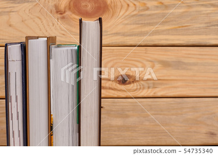 Books on wooden background and copy space. Books on wooden background and copy space. 54735340