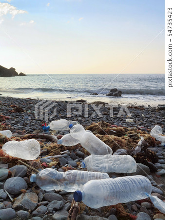 Plastic bottles washed on the atlantic shoreline 54735423