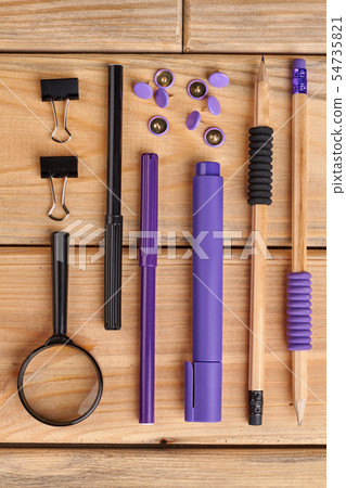 Set of stationery items on a wooden background. 54735821