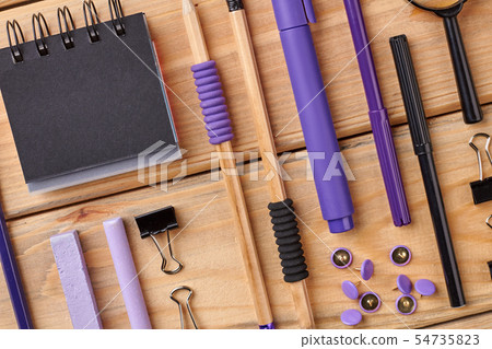 Spiral notepad and stationery supplies on wooden table. Spiral notepad and stationery supplies on wooden table. 54735823