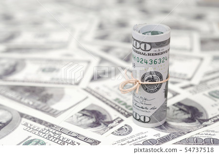 US dollars rolled up and tightened with band lies US dollars rolled up and tightened with band lies 54737518