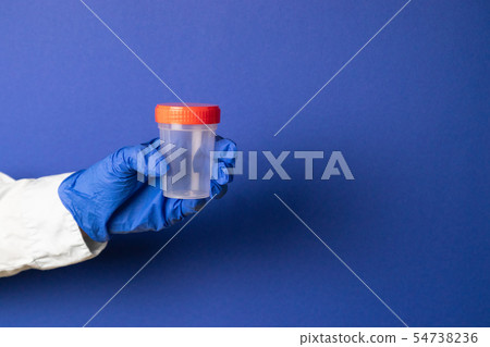 Doctor's hand in latex blue gloves holds a plastic Doctor's hand in latex blue gloves holds a plastic 54738236
