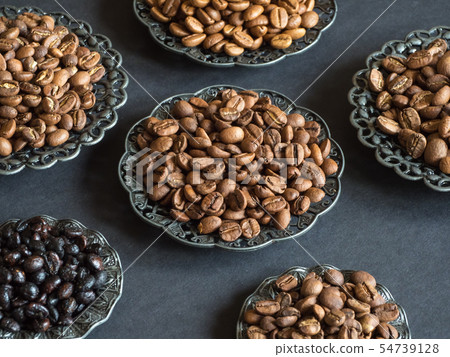 Varieties of roasted coffee beans on a black table 54739128