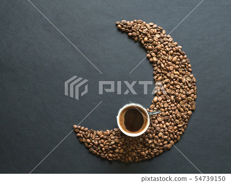 Crescent shape made of coffee beans and cup coffee 54739150