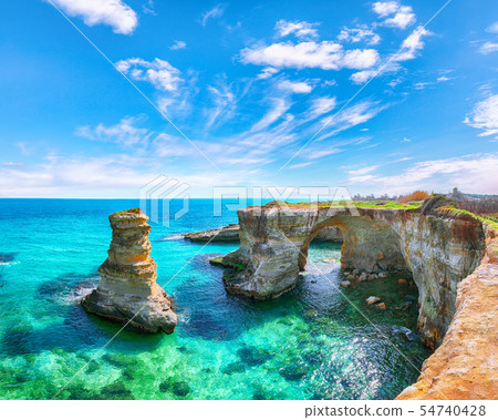 Picturesque seascape with cliffs, rocky arch at 54740428