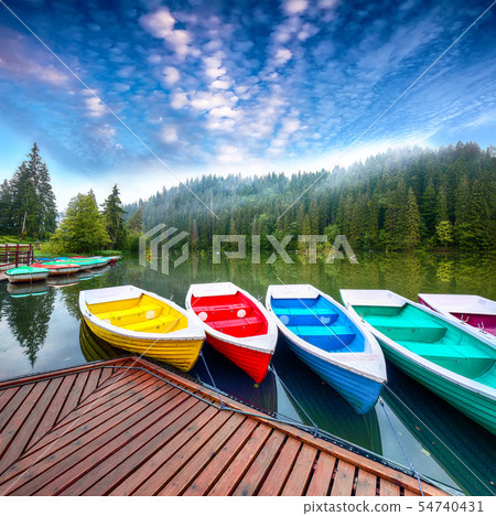 Boats on majestic mountain lake Lacul Rosu or Red 54740431