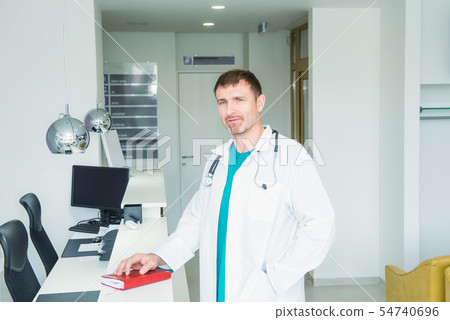 Mature male confident Doctor's portrait standing 54740696