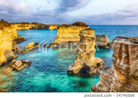 Dramatic seascape with cliffs, rocky arch at Torre 54740806