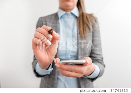 Business woman holds mobile phone in the hand Business woman holds mobile phone in the hand 54741813