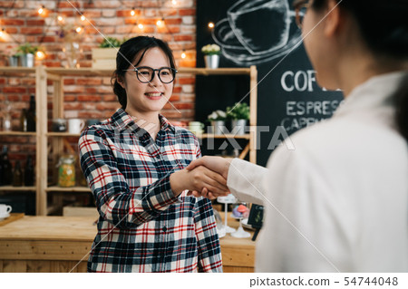 recruiter at table shaking hands with applicant recruiter at table shaking hands with applicant 54744048
