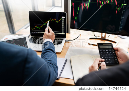 Team of stockbrokers Discussing with display scree Team of stockbrokers Discussing with display scree 54744524