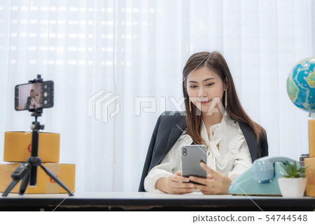 Young Asian woman as vlogger or blogger attending 54744548