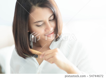 Woman looking reflection in the mirror serious Woman looking reflection in the mirror serious 54744672