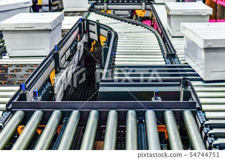 White plastic box on conveyor belt at industrail 54744751