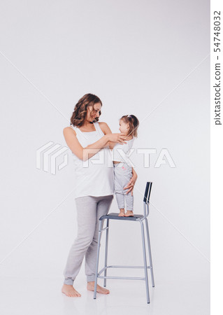 mom and daughter having fun on a white background. mom and daughter having fun on a white background. 54748032