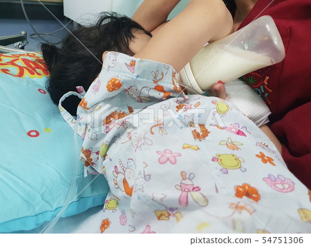 Children are sleeping in milk from a bottle in th 54751306