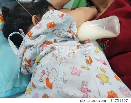 Children are sleeping in milk from a bottle in th 54751307