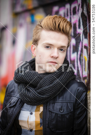 Fashion male portrait on graffiti wall Fashion male portrait on graffiti wall 54753186