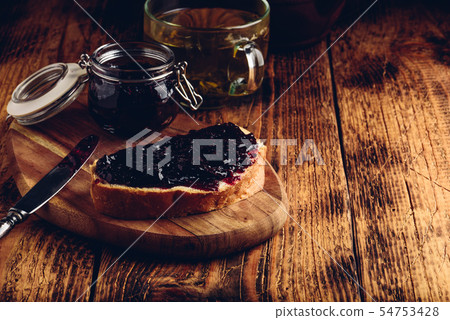 Toast with berry jam and green tea 54753428