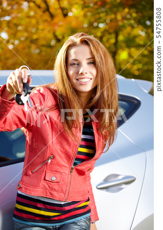 Happy smiling woman with car key. Driving. 54755808