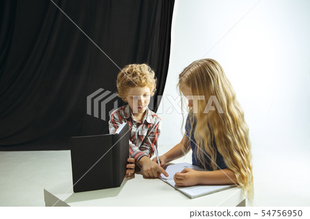 Boy and girl preparing for school after a long summer break. Back to school. Boy and girl preparing for school after a long summer break. Back to school. 54756950