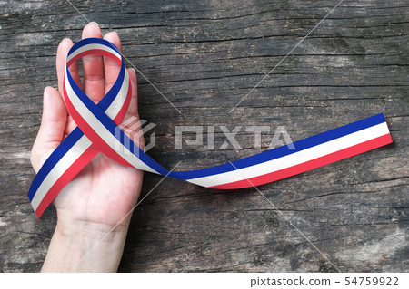 Red white blue flag pattern ribbon on people hand  54759922
