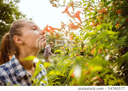 Young and happy farmer's couple at their garden in sunny day 54760577