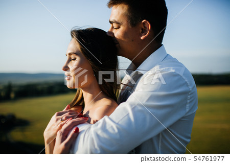 Photo of young loving couple cuddling. Photo of young loving couple cuddling. 54761977