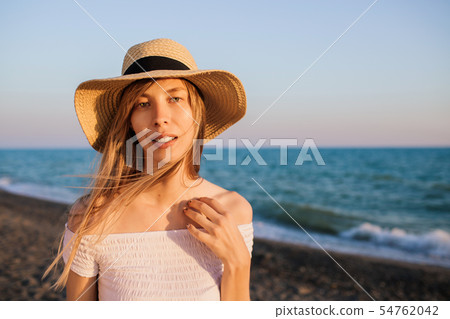 Young attractive tourist girl relaxing at the beach. 54762042
