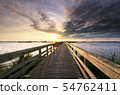 evening sunshine over wooden bridge 54762411
