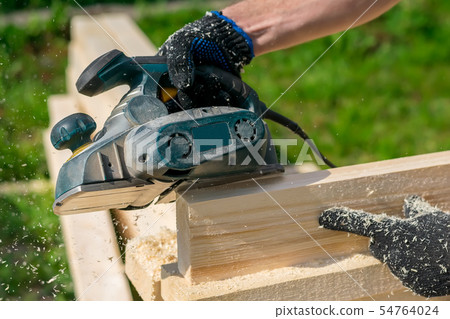 man planing boards with electric tools man planing boards with electric tools 54764024