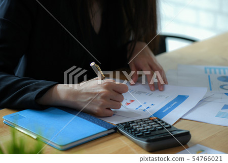 Female executives are finalizing a budget plan. Female executives are finalizing a budget plan. 54766021