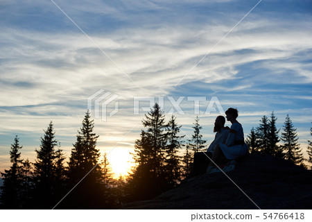Silhouettes of couple in love at sunset in the mountains 54766418