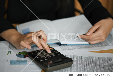 Accounting staff is summarizing data on the desk. Accounting staff is summarizing data on the desk. 54766440