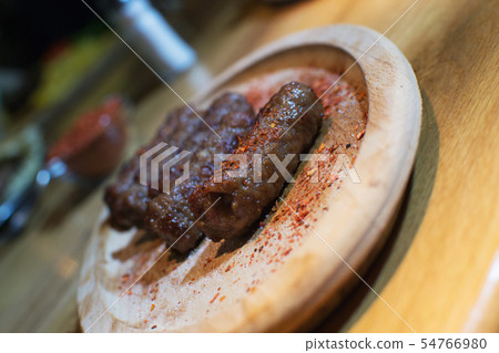 Classic kebabs on the plate. 54766980