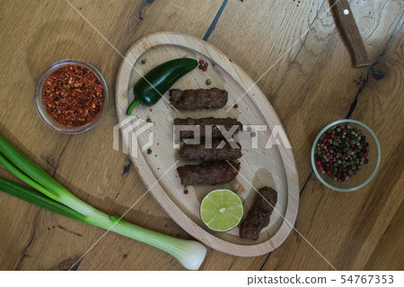 Classic kebabs on the plate. 54767353