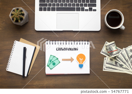 Office table with laptop, money and notepad with crowdfunding 54767771