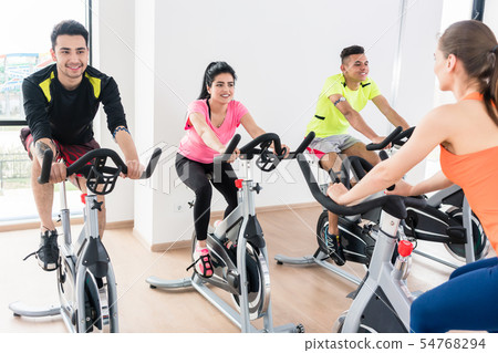 People cycling at gym People cycling at gym 54768294
