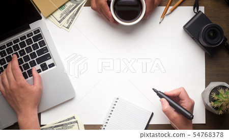 Woman hand looking for something on laptop and holding marker 54768378