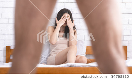 Woman in disbelief looking what's between man's legs Woman in disbelief looking what's between man's legs 54768510