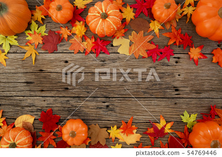 Autumn leaves on wooden background 54769446