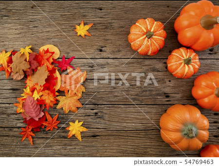 Autumn leaves on wooden background Autumn leaves on wooden background 54769463