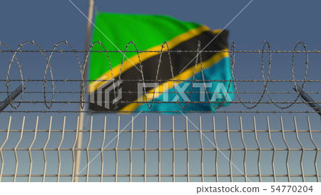 National flag of Tanzania behind barbed wire fence. Conceptual 3D rendering National flag of Tanzania behind barbed wire fence. Conceptual 3D rendering 54770204