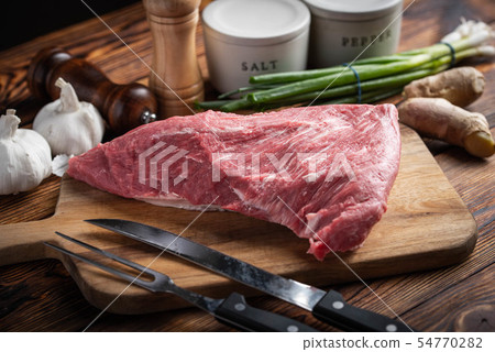 raw tri tip steak beef on wooden cutting board 54770282