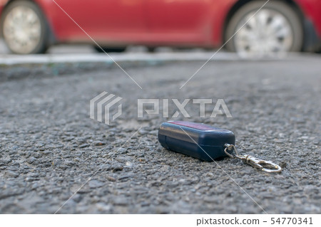 The lost keychain, car alarm remote on the road 54770341