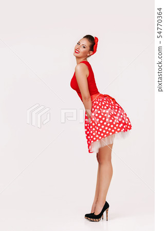 smiling pin up woman in polka dot red dress smiling pin up woman in polka dot red dress 54770364