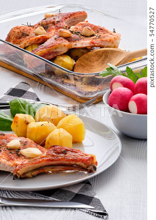 Steak with bone and potato baked in oven Steak with bone and potato baked in oven 54770527