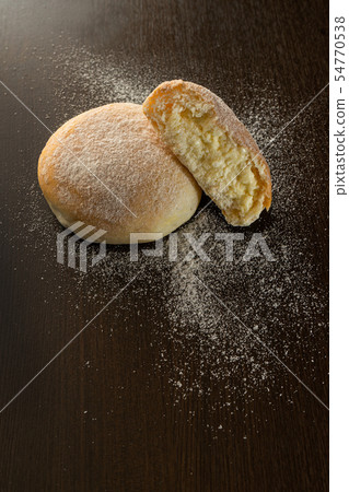 butter buns with powdered icing sugar on dark wood butter buns with powdered icing sugar on dark wood 54770538
